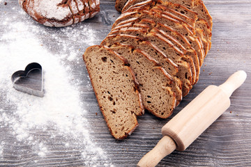 freshly baked bread on wooden board. cutted bread