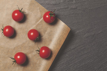 Fresh red cherry vine tomatos on a brown paper background