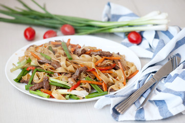 Wok. Noodles with meat and vegetables in Chinese