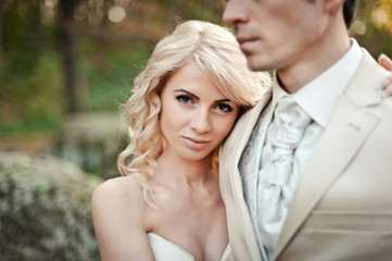 Wedding couple in white dresses for a walk in the park