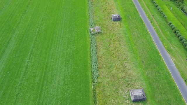 Aerial of old shelter bunkers from world war two in the middle of a meadow near Culemborg, the Netherlands &ndash; 4K