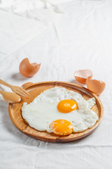 Fried egg in wood plate