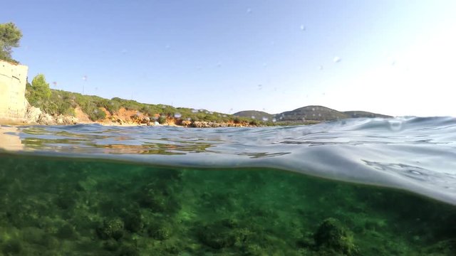 Split underwater view of Alghero shoreline. Sardinia, Italy