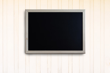 blank chalkboard hang on the white wooden wall for remind information, appointment or meeting in work.