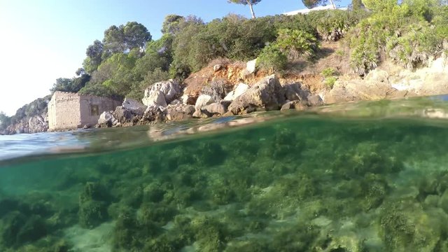 Split underwater view of Alghero shoreline. Sardinia, Italy