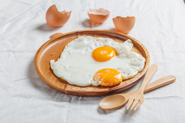 Fried egg in wood plate