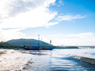Alone fishing boat with net wooden arms  moored in the sea