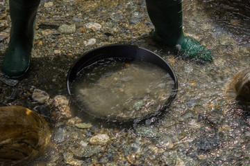 a full gold pan in the river