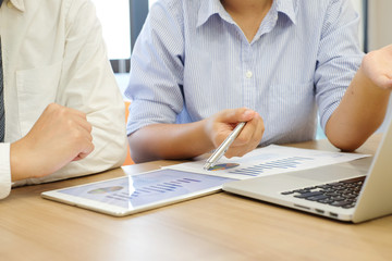 close up investor businesswoman hand point on tablet pad display for consult stock statistic graph with businessman for business technology concept