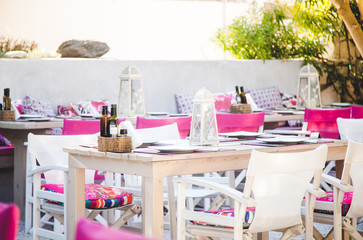 Decorated table with candles and silverwear in open garden
