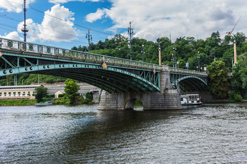 Fototapeta na wymiar Art Nouveau style Svatopluk Cech Bridge (Most Svatopluka Cecha) over the Vitava River in Prague, Czech Republic. Svatopluk Cech Bridge: length is 169 m and width is 16 m.
