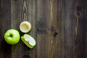 Apple puree for baby on dark wooden table background top view copyspace