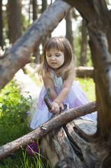 Angry little girl in white dress in the forest. Forest Nymph. Sunny day