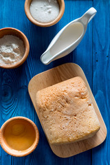 Homemade bread. Loaf and ingredients on blue wooden table background top view