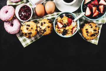 Tasty fresh breakfast food ingredients on black dark background. Ready to cook. Home Healthy Food Cooking Concept.