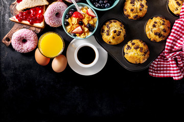 Tasty fresh breakfast food ingredients on black dark background. Ready to cook. Home Healthy Food...