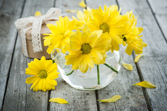 Hand crafted gift and yellow daisies