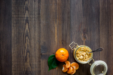 Sweet summer breakfast. Oatmeal, oranges, sugar on wooden table background top view copyspace
