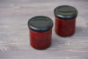 Small glass jars with strawberry jam