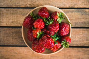 ripe strawberries on wooden background top view