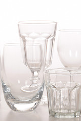 Empty crystal glasses and glasses and a bottle