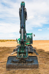 Excavator on the territory of beginning construction