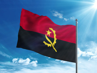 Angola flag waving in the blue sky