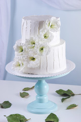 White bunk wedding cake decorated with flowers