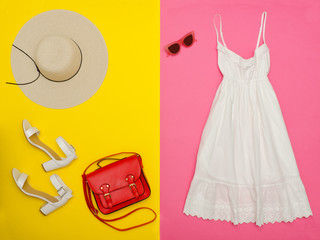Female wardrobe. White sundress, handbag, white shoes and a hat. Bright pink-yellow background. fashion concept