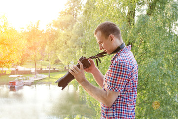 Photographer is viewing his work on the camera, outdoors