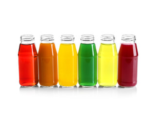 Different juices in bottles on white background