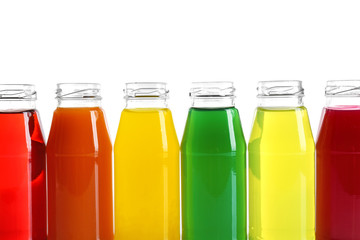 Different juices in bottles on white background