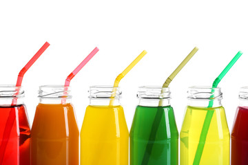 Different juices in bottles on white background
