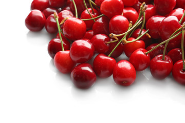Obraz na płótnie Canvas Heap of sweet cherries on white background
