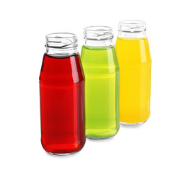 Different juices in bottles on white background