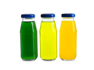 Different juices in bottles on white background