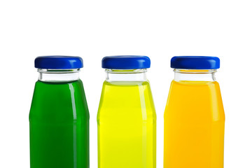 Different juices in bottles on white background