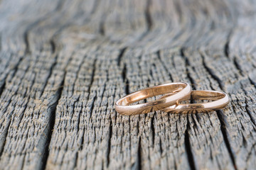 Wedding rings on wooden background. Natural,