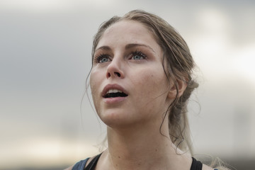 a woman looking up catching her breath after running