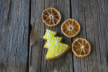 Dried oranges and cakes on wooden background. Christmas concept