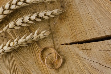 Wheat and wedding rings. Concept of rustic wedding