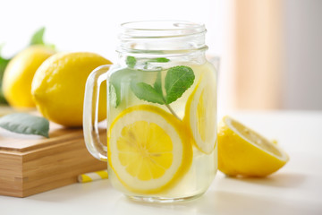 Glass jar with lemonade on light table