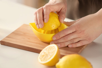 Woman preparing lemonade in kitchen, closeup