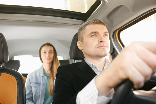 Male Taxi Driver And Female Passenger In Car