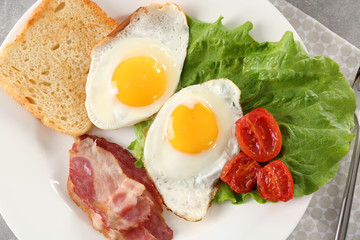 Tasty breakfast with fried eggs on plate