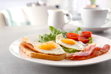 Tasty breakfast with fried eggs on table