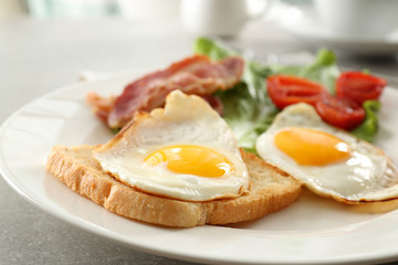 Tasty breakfast with fried eggs on table