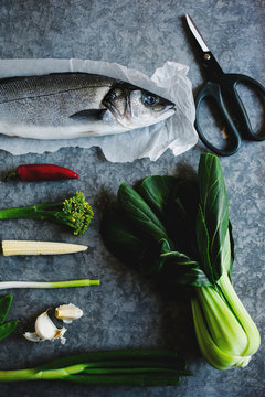 Sea bass and ingredients for cooking.