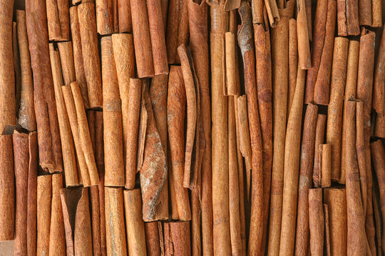 Many cinnamon sticks as background