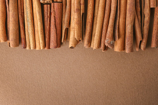 Aromatic cinnamon sticks on cardboard background
